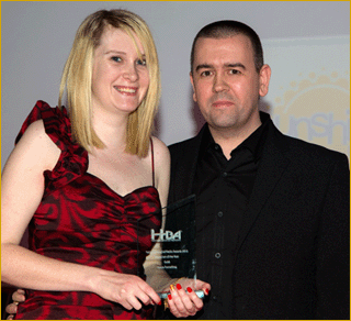 Laura collects her award from Roy Martin of Radio Today